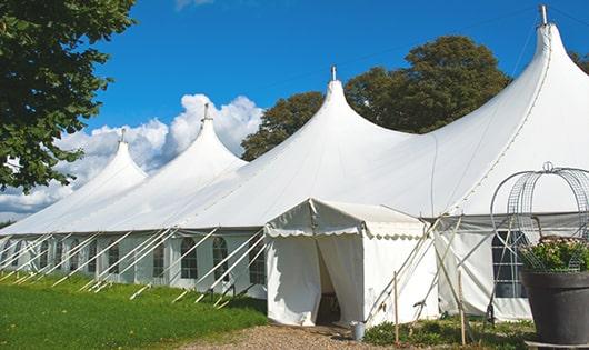 a line of sleek and modern portable toilets ready for use at an upscale corporate event in Oakboro